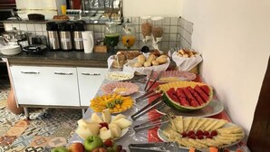 Une table de buffet proposant une variété de fruits, de fromages et de pains.