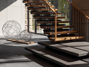 A modern staircase with wooden steps and black railings, leading to an upper level. - Mitsui Garden Hotel Jingugaien Tokyo Premier (Tokyo)
