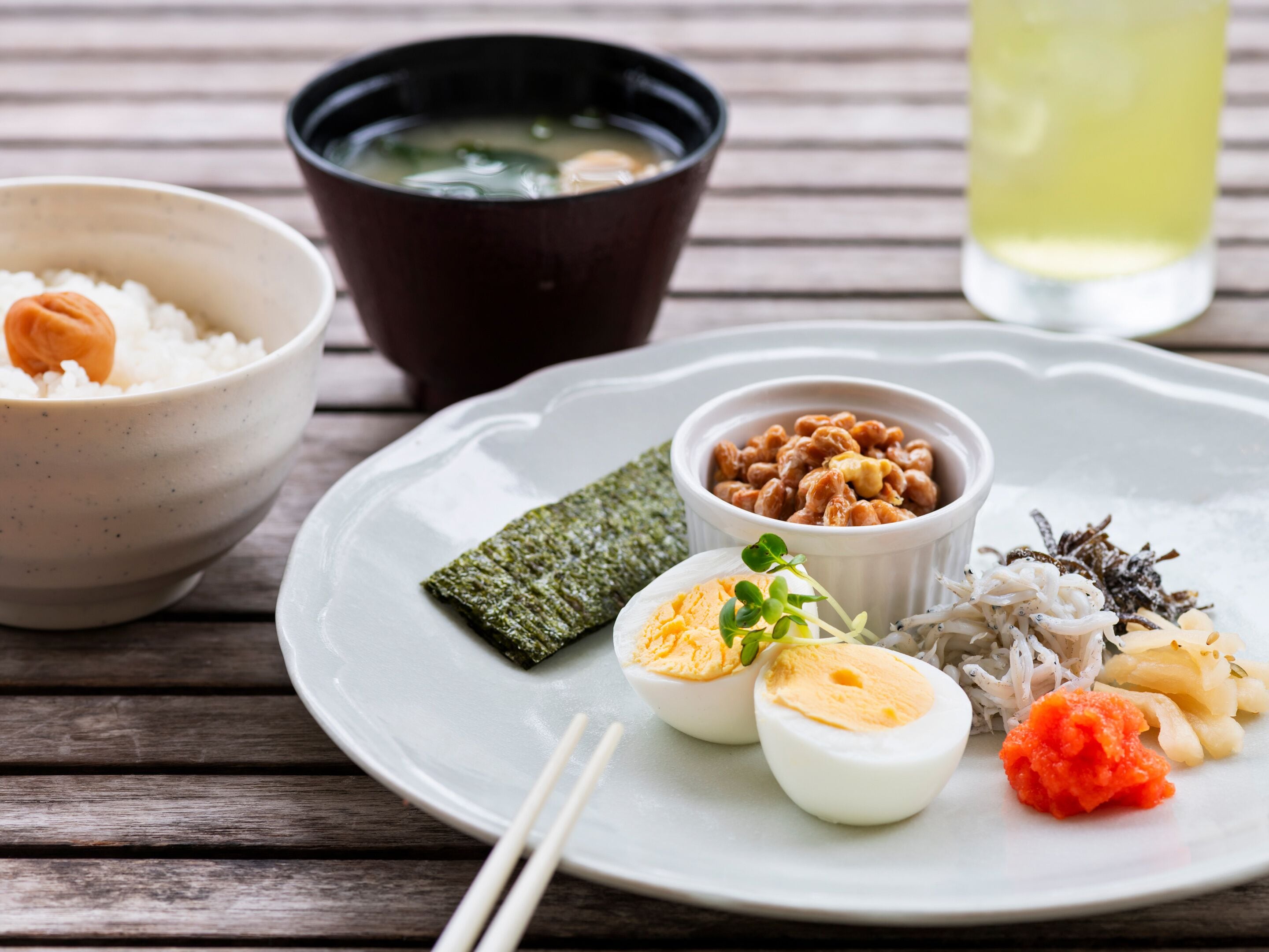 A plate with various Japanese dishes including rice, soup, and a variety of side dishes.