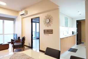 One Pacific Residences 2A | Living area | 32-inch flat-screen TV with cable channels, TV, Netflix - One Pacific Residences (Lapu-Lapu)