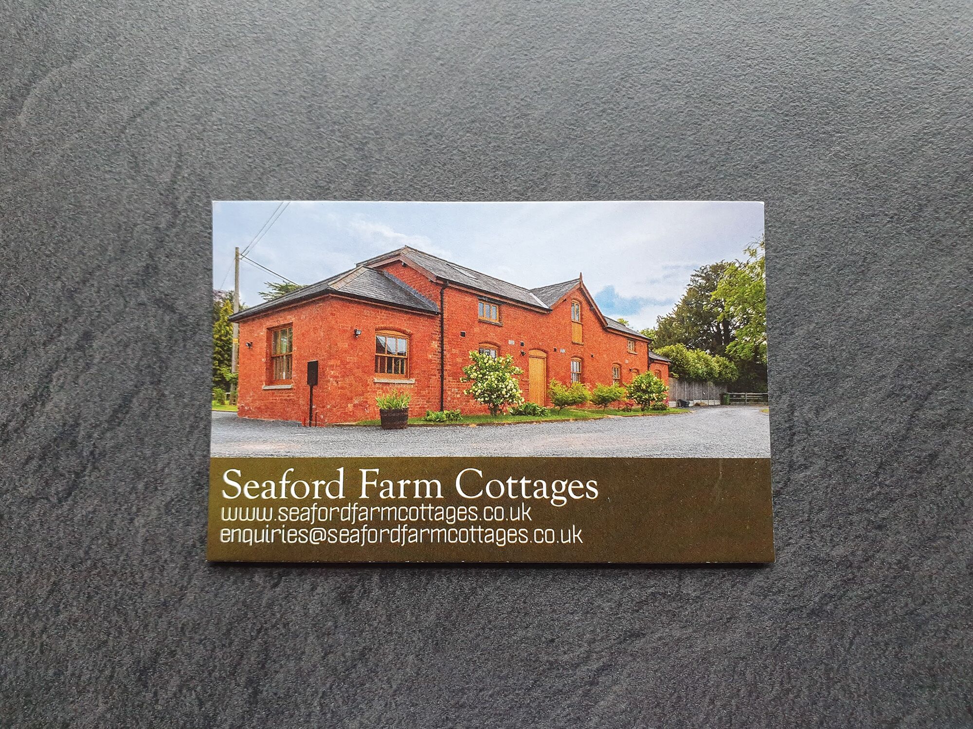A brochure for Seaford Farm Cottages with a photo of a red brick building.