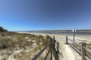 A sandy beach path with a wooden fence and a signpost. - MERMAID COTTAGE - 3 MINUTE WALK TO BEACH - VERY CHARMING & CLEAN! (Villas)