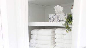 A white storage unit with shelves holding folded towels and a tissue box. - Small Home Paradise - close to Lancaster attractions (Paradise)