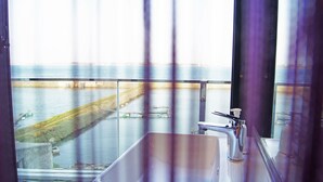 A bathroom with a view of a river and a bridge. - Simple Life Home Stay (Magong)