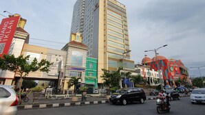 A multi-story building with a prominent sign at the top. - Sun Apartment Semarang (Semarang)