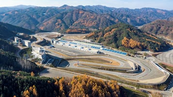 An aerial view of a race track with a grandstand and buildings.