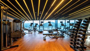 A gym with exercise equipment, large windows, and a view of mountains. - Take Hotel & Resort Inje Speedium (Inje)