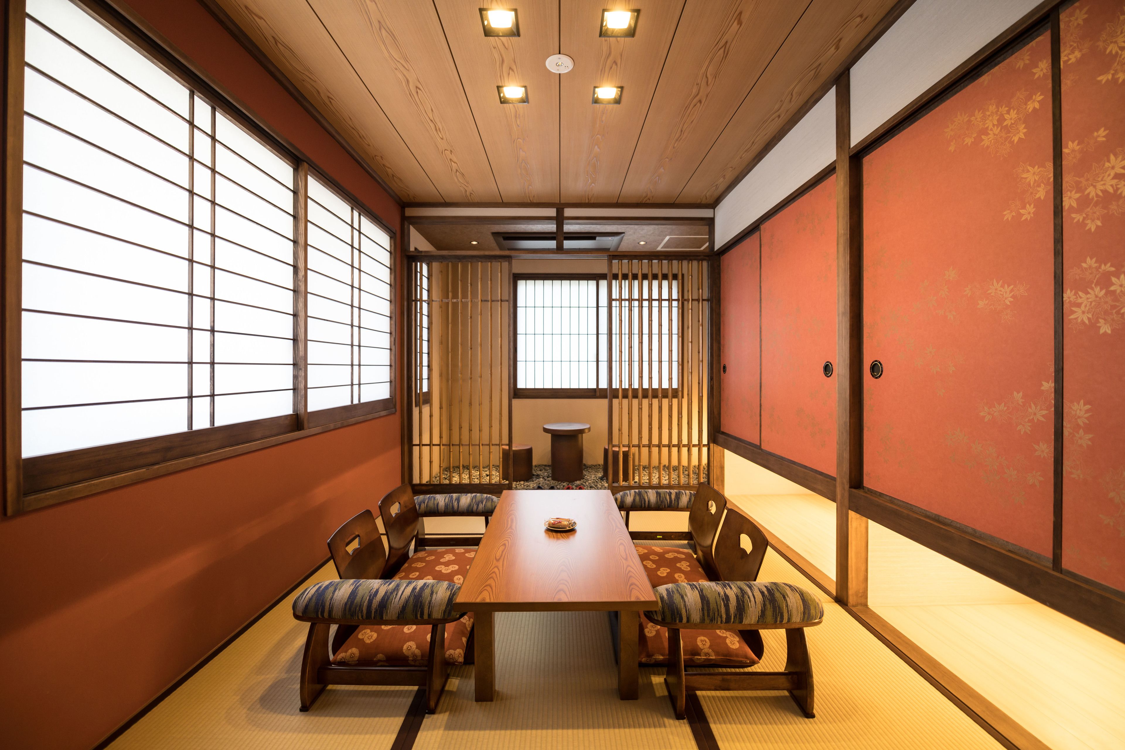 A traditional Japanese room with tatami flooring, a low table, and shoji screens.