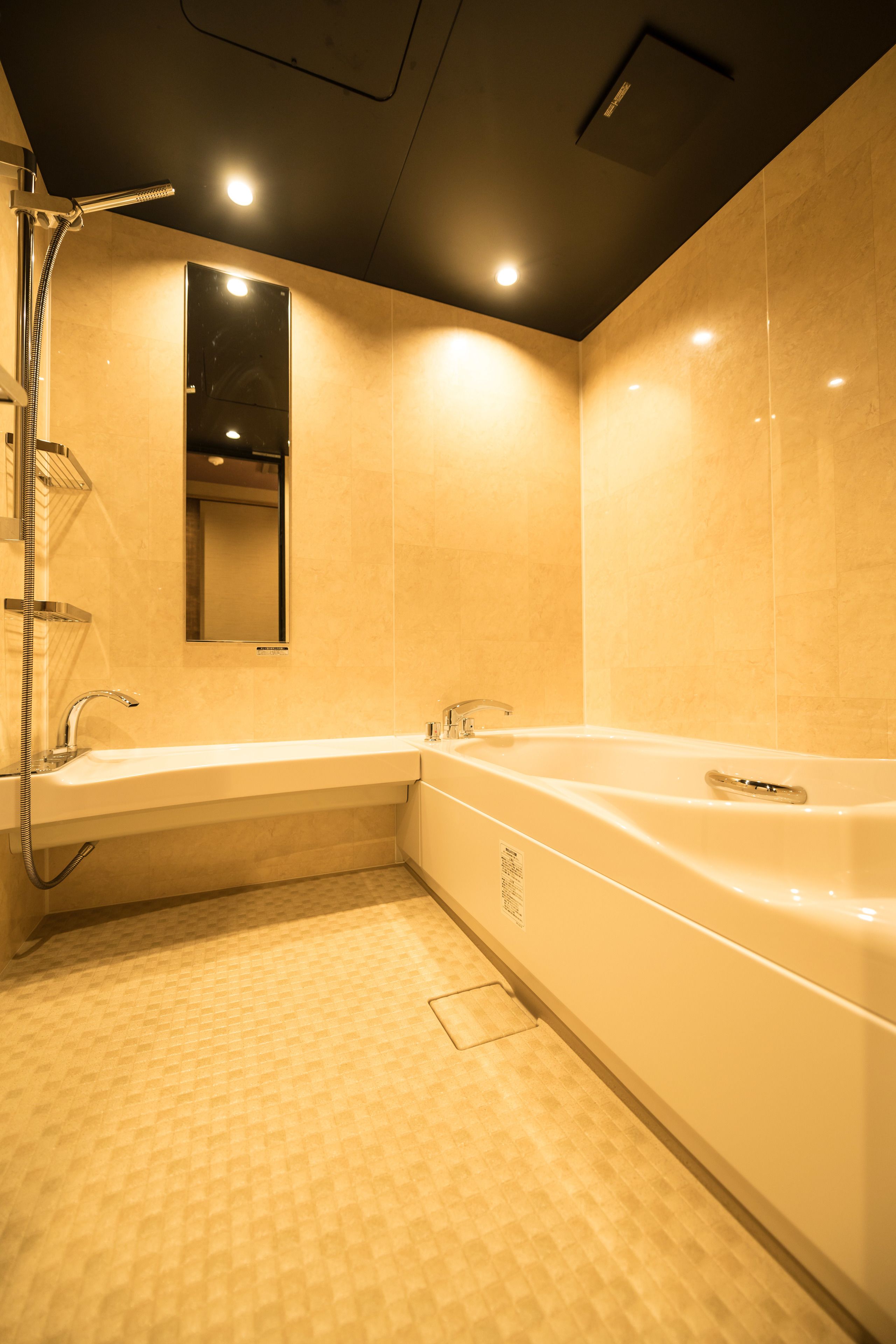 A modern bathroom with a bathtub, a shower, and a mirror.