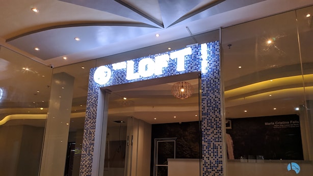 Entrada de hotel con un arcoado de azulejos y un mostrador de recepción.