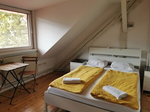 A room with a bed, a small table, and a window. - Hostel Most (Ljubljana)