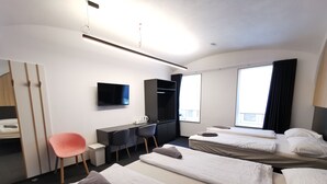 A hotel room with two beds, a desk, a chair, a TV, and a wardrobe. - Cha Cha Rooms (Ljubljana)
