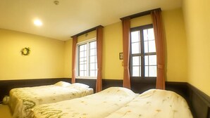 A hotel room with two single beds, a window with curtains, a wall clock, and a wreath on the wall. - Pension Wildflowers (Tateshina)
