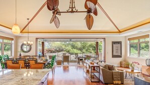 A spacious open-plan living area with a kitchen, dining area, and seating space. - Stunning 4BR KaMilo Home 349 at Mauna Lani – Relaxed Elegance & Pool/Spa (Kamuela)