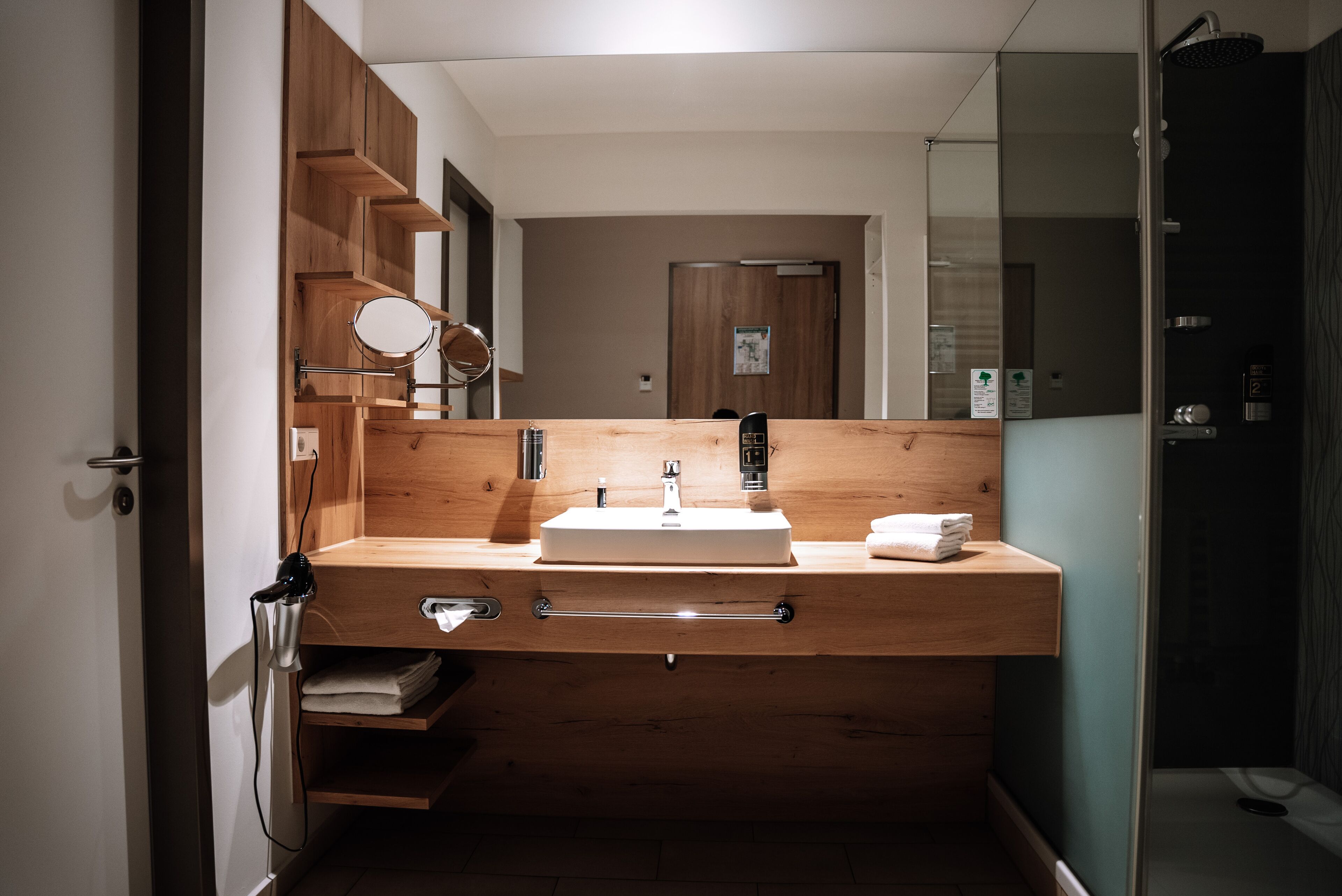 shower, hair dryer, slippers, towels