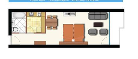A floor plan of a hotel room with a kitchen area, a seating area with a sofa and chairs, and a large bed.