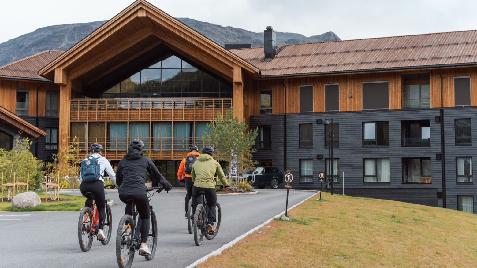 A building with a large wooden facade and a modern design, featuring a prominent entrance and large windows.