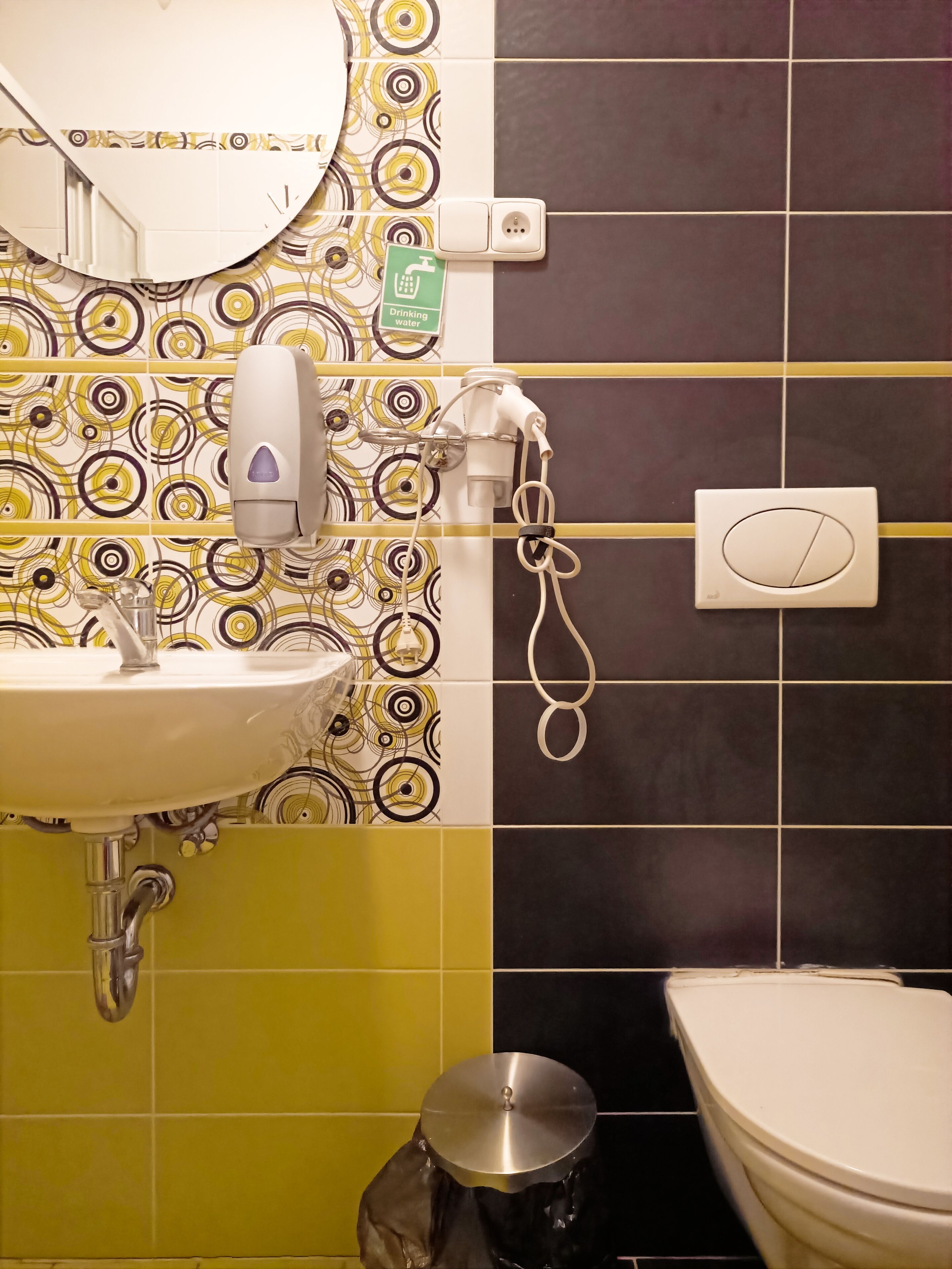 A bathroom with a sink, mirror, and toilet.