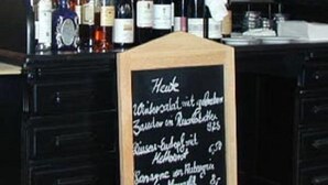 A blackboard with handwritten text listing prices for various items. - Hotel Lederfabrik (Muelheim an der Ruhr)