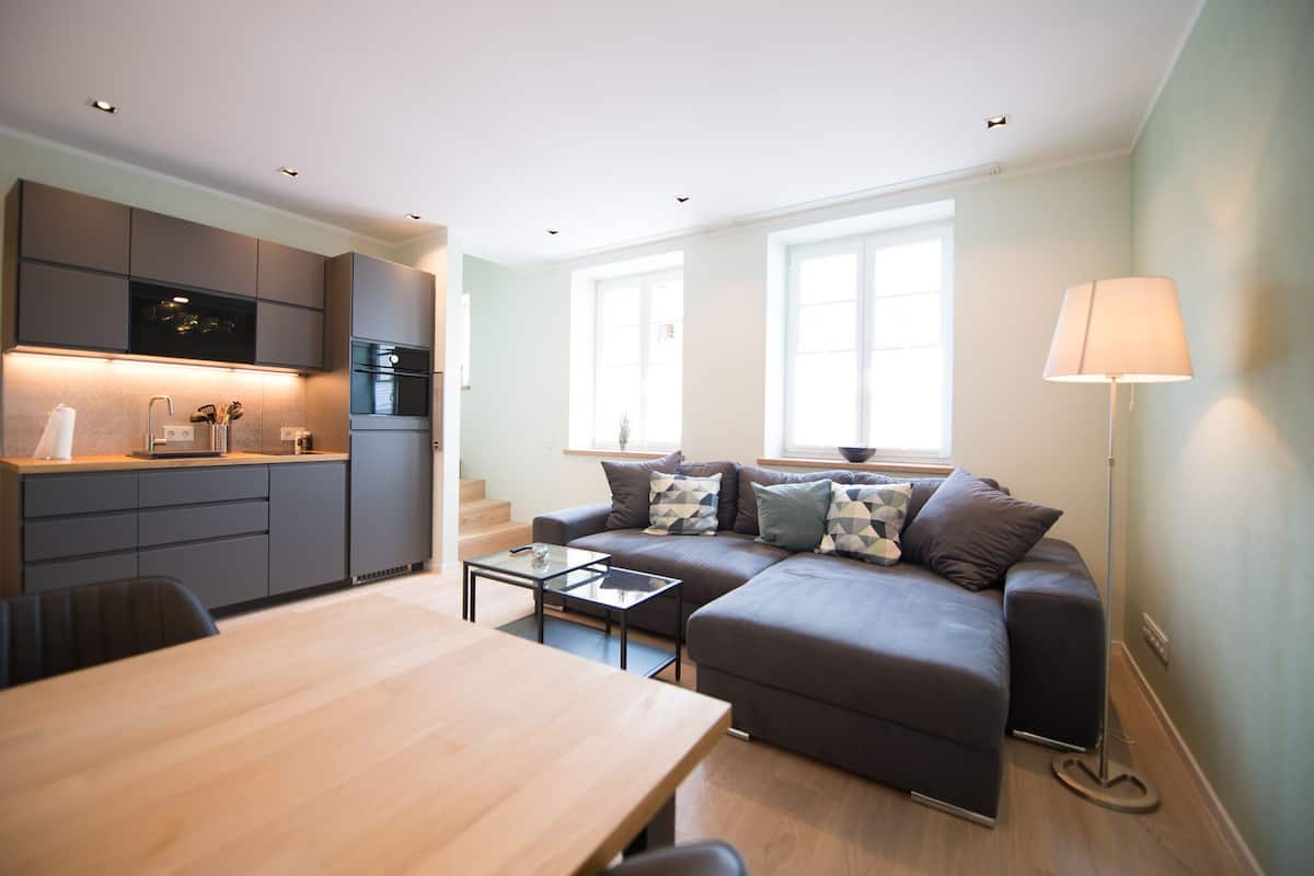 A modern apartment with a kitchen, dining area, and living room.
