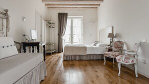 Ett hotellrum med en säng, en stol, ett skrivbord och en garderob.