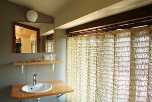 A bathroom with a wooden vanity, a white sink, a mirror, and a shower curtain. - Art and Relax - Paperki enea (Hondarribia)
