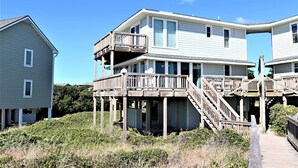 A two-story house with a wooden deck and stairs leading to a balcony. - Oceanfront 4BR with Panoramic Views & Beach Access (Emerald Isle)