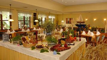 A buffet setup with various food items and decorations.