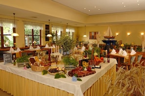 A buffet setup with various food items and decorations.