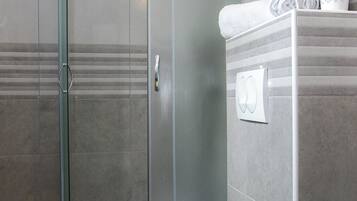 Shower, hair dryer, towels, toilet paper
