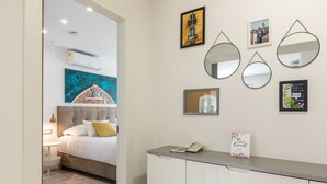 A hotel room with a bed, bedside table, and a desk with a phone and a sign. - Lux Private Guest Suite Superb Location (Split)