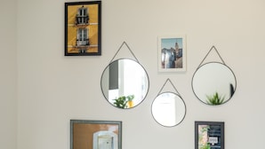 A wall with various framed pictures and mirrors. - Lux Private Guest Suite Superb Location (Split)