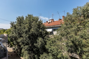 A residential building with a tiled roof, satellite dishes, and dense surrounding trees. - Lux Private Guest Suite Superb Location (Split)