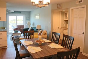 Enjoy meals with family and friends at the large dining table in this spacious living area.