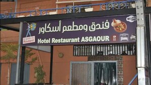 A sign for Hotel Restaurant ASGAOUR with a Wi-Fi symbol, a restaurant logo, and a sign for the Route 44.