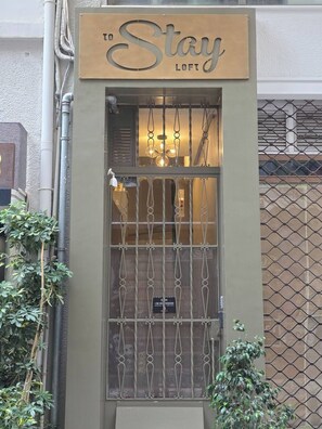 Um edifício com uma placa que diz 'To Stay LOFT'.