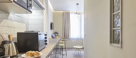 A modern kitchen with a built-in oven, a coffee maker, and a toaster.