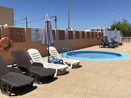 Outdoor pool, pool umbrellas, sun loungers