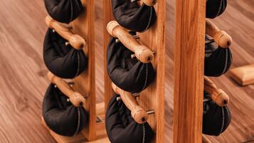 A wooden shoe rack with multiple compartments for storing shoes.