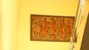 A staircase with a framed artwork above it. - Hotel Sweet Inn (Lahore)