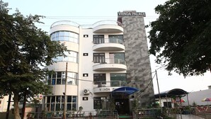 A multi-story building with a sign reading "VRINDA PALACE". - Vrinda Palace (Mathura)