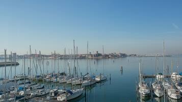 A marina with numerous boats docked at wooden piers.