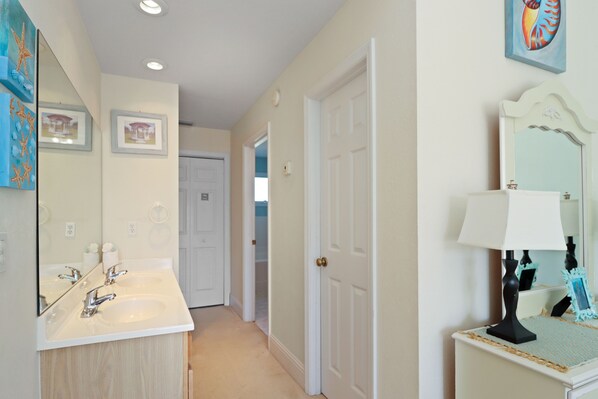 A bathroom with a double sink, a mirror, and a vanity with a lamp. - Overlooking The Pool and Pond~ Short Walk To Beach (Cape San Blas)