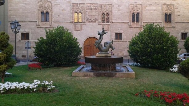 A building with a central fountain and a statue, surrounded by well-maintained gardens and a traditional architectural style. - Zamora Apartments (Zamora)