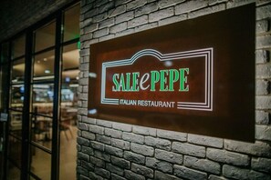 A sign for 'Sale Pepe Italian Restaurant' mounted on a brick wall. - Napa Plaza Hotel-adults Only (AYIA NAPA)