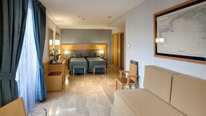 A hotel room with two beds, a sofa, a desk, and a map on the wall. - Del Mar Hotel (Barcelona)