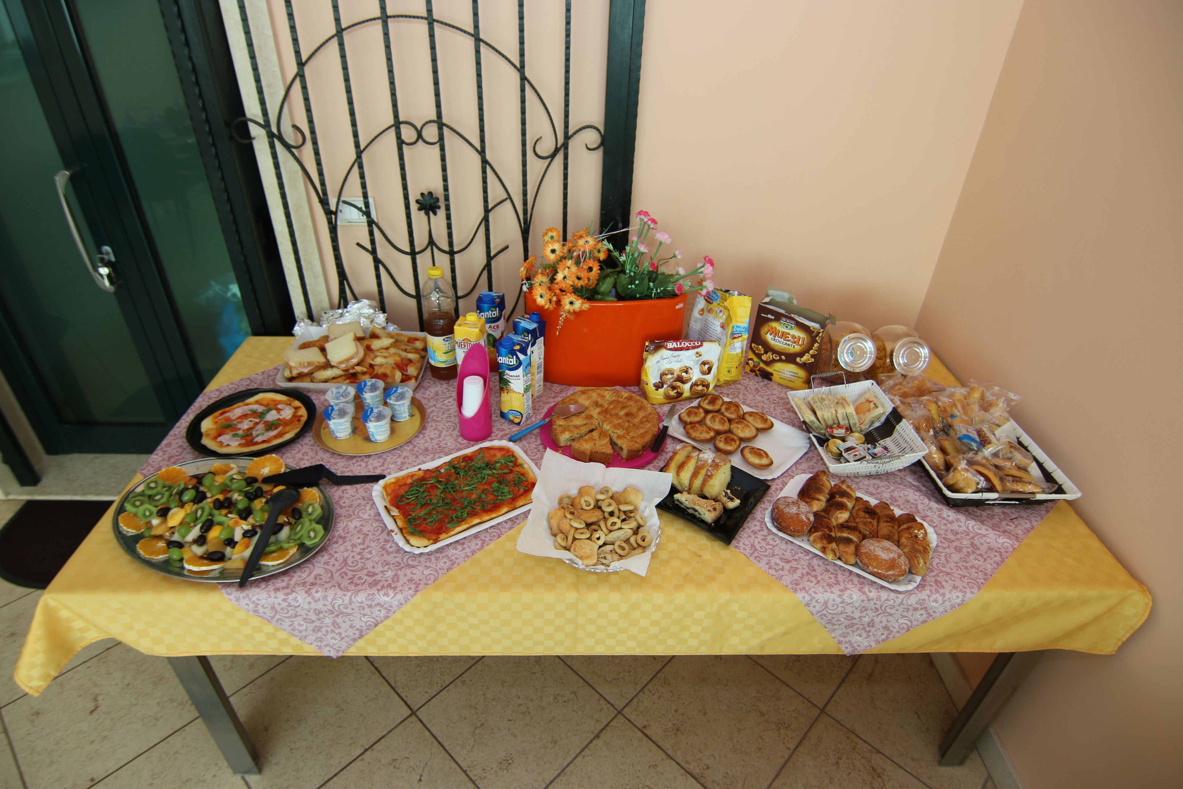 A table with various food items and a decorative plant.
