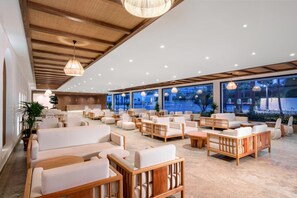 A spacious indoor area with multiple seating arrangements, large windows, and a wooden ceiling. - Yalihan Aspendos Hotel (Alanya)