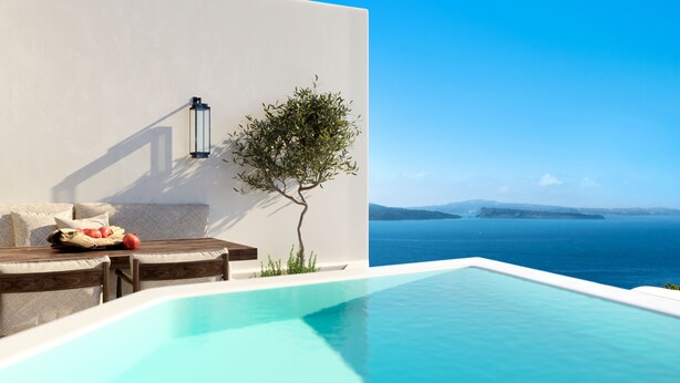 A modern pool area with a clear view of the sea and distant landforms. - Alta Mare By Andronis (Santorini)