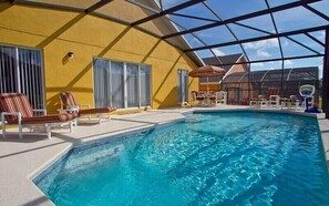 An indoor swimming pool with clear blue water, surrounded by sun loungers and a covered seating area. - Vizcay Villa - Three Bedroom Home (Davenport)